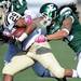 Western Michigan sophomore Tevin Drake looks to run the ball past Eastern Michigan junior Bryan Pali during the second half against Western Michigan at Rynearson Stadium on Saturday afternoon. Melanie Maxwell I AnnArbor.com